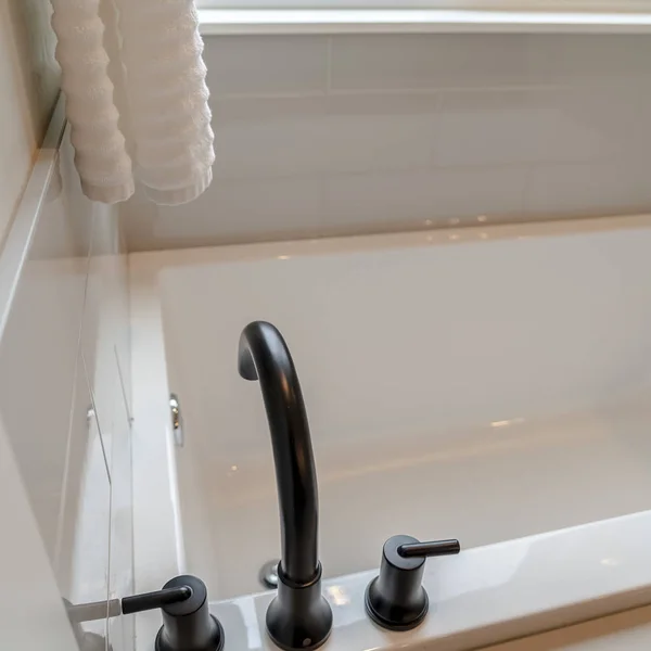 Foto Rubinetto nero opaco quadrato e maniglie su un bianco pulito lucido costruito nella vasca da bagno — Foto Stock