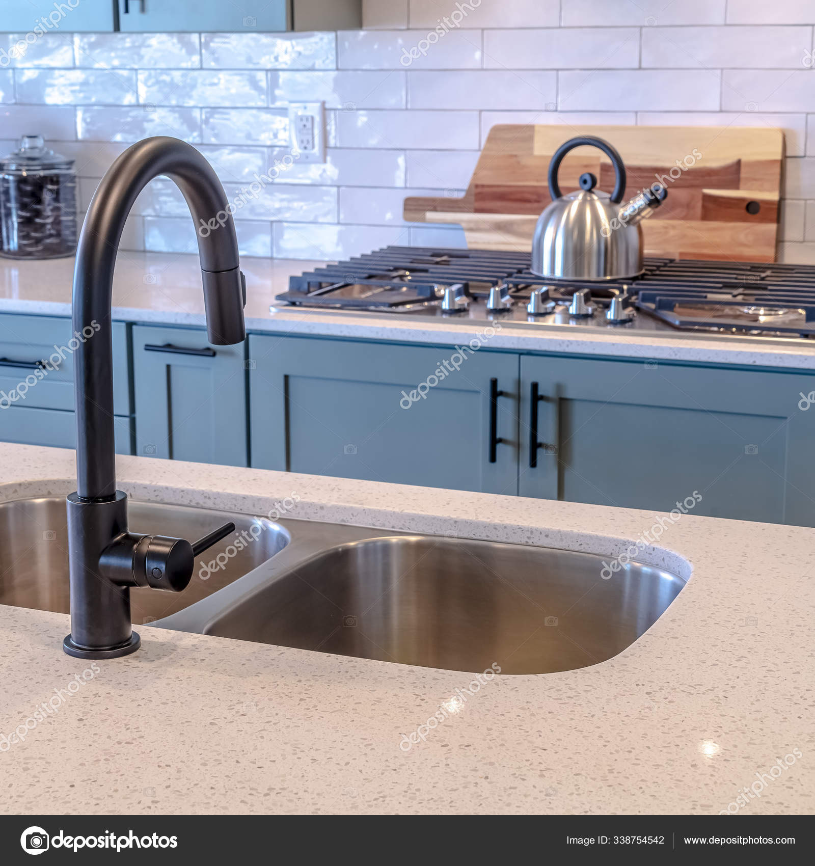 Photo Square Frame Kitchen Island Double Sink And Black Faucet Against Cooktop And Tile Backsplash Stock Photo By C Dropthepress Gmail Com