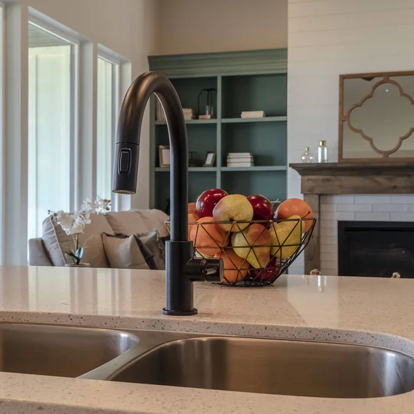 Photo Square Kitchen island sink with black faucet fruit basket and double basin sink