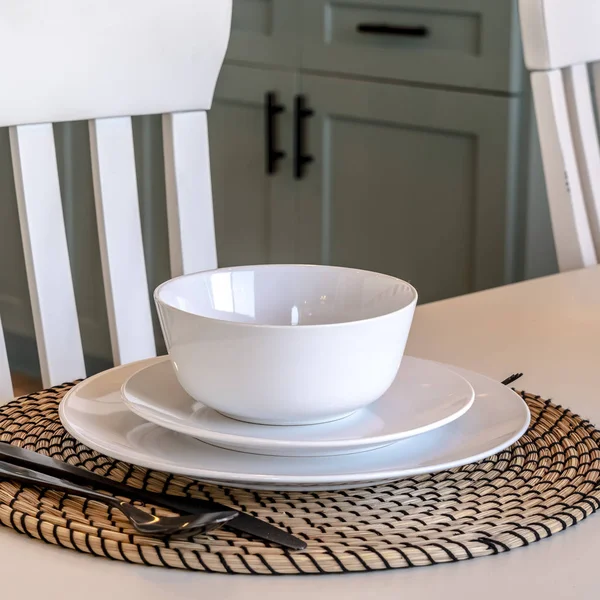 Square Dining table setting of home against chairs wooden floor and kitchen cabinets