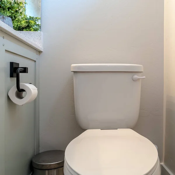 Square Toilet trash can and cabinet with tissue holder against white wall of bathroom — Stock Photo, Image