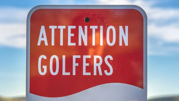 Panorama frame Attention Golfers sign at a golf course with blurry mountain and sky background — Stockfoto