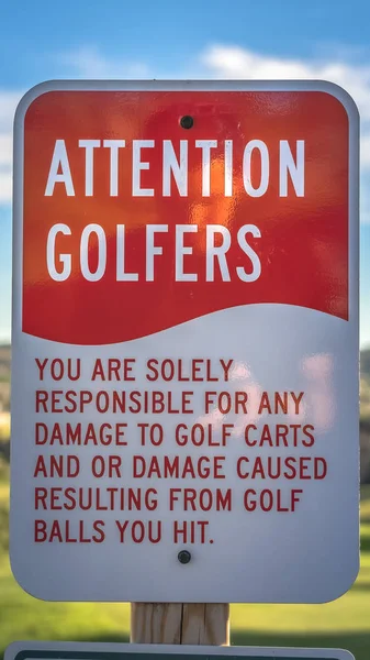 Vertical Attention Golfers sign at a golf course with blurry mountain and sky background — Stockfoto