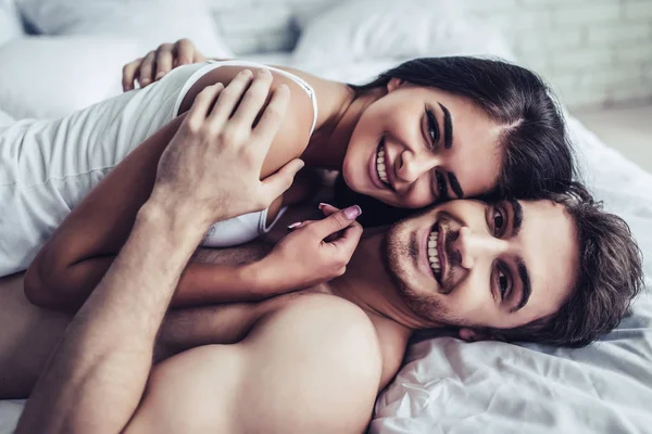 Joven pareja de amor en la cama — Foto de Stock