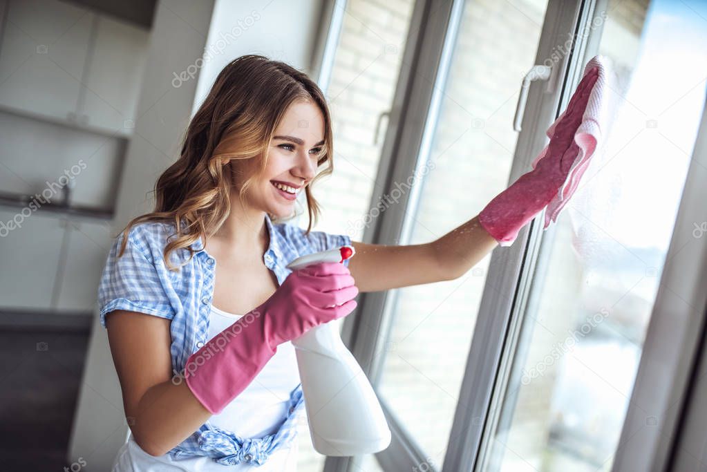 Young woman is doing cleaning at home