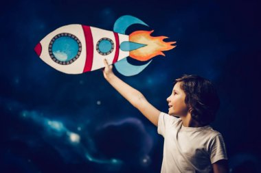 Boy with toy rocket in space clipart