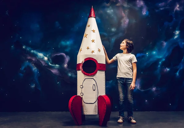 Boy with toy rocket in space — Stock Photo, Image