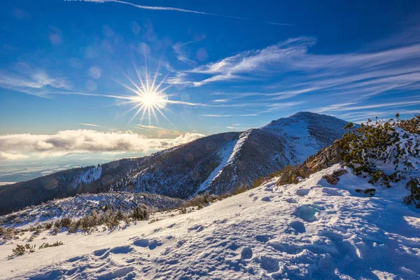Winter mountain landscape at a sunny day with fog in the valleys — Stock Photo, Image