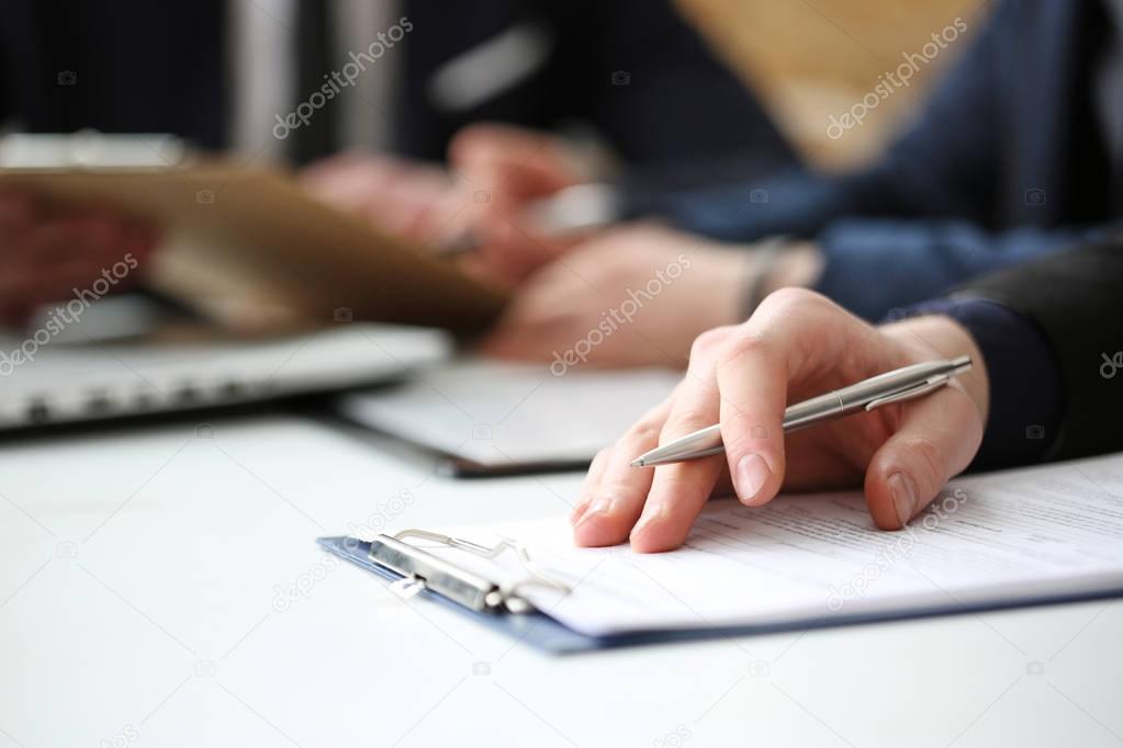 Hand of businessman signing document with pen