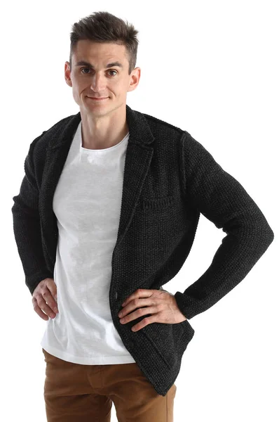 Retrato de un hombre atractivo en un suéter y un chaleco, cogido de la mano en su cinturón —  Fotos de Stock