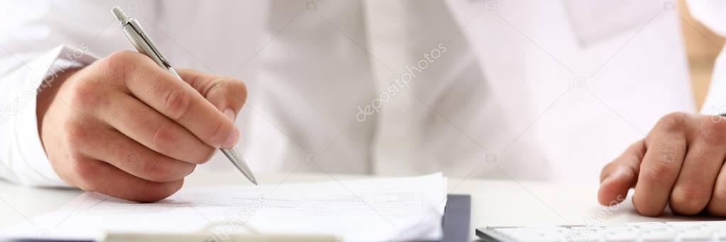 Hand of businessman with silver pen
