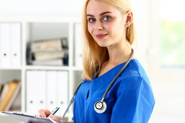 Beautiful smiling female doctor hold clipboard