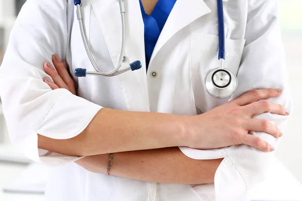 Médico femenino manos cruzadas en el pecho — Foto de Stock