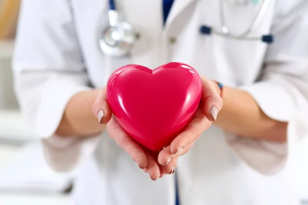 Lekarz medycyny kobiece ręce, trzymając czerwony serce — Zdjęcie stockowe