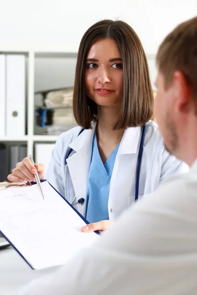 Mujer médico mano mantenga la pluma de plata y la almohadilla que muestra — Foto de Stock