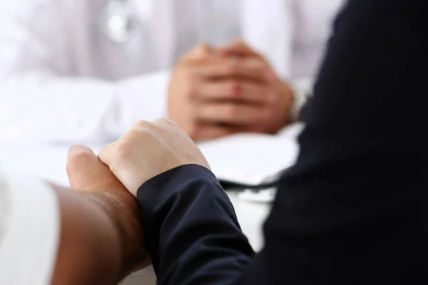 Young couple hold hands together in doctor office closeup — Stock Photo, Image