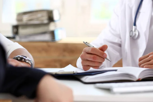 Male doctor hold silver pen discuss problem with family couple