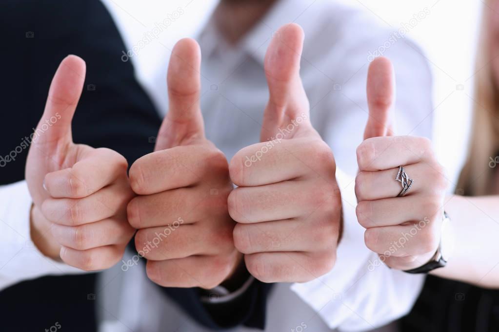 Group of people showing OK or approval sign with thumb up