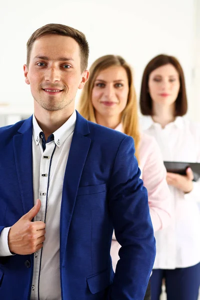 Group of smiling people stand in office