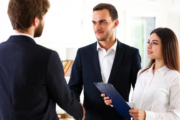 Smiling man in suit shake hands as hello in office — Stock Photo, Image