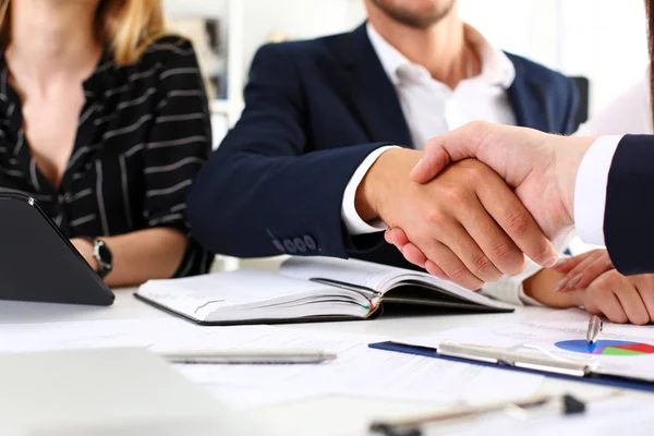 Man in suit shake hand as hello in office closeup