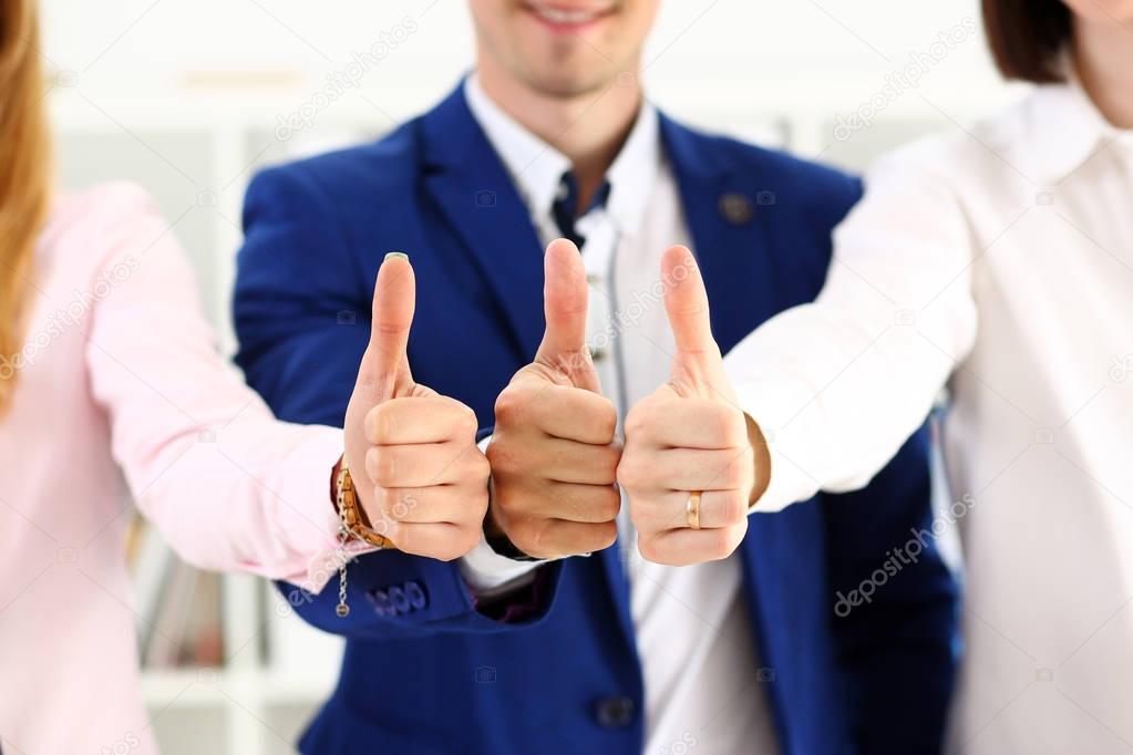 Group of people show OK or approval with thumb up