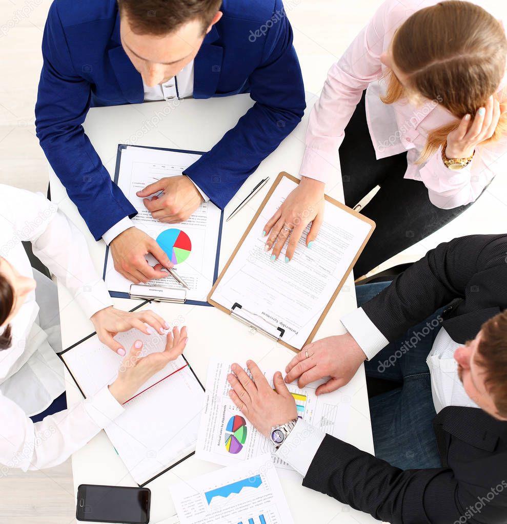 Group of people discuss plan at workplace closeup