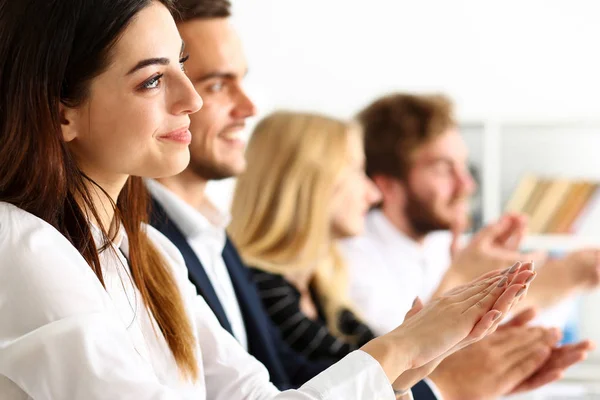 Group of people clap their arm in row