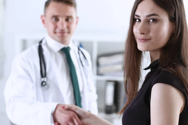 Handsome male doctor shake hand as hello with patient — Stock Photo, Image