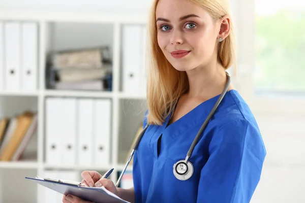 Beautiful smiling female doctor hold clipboard