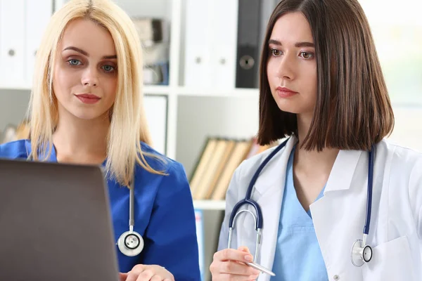 Group of doctors using laptop pc sitting in office