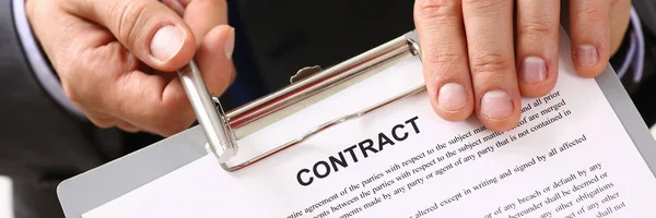 Handsome man in suit offer contract form on clipboard pad — Stock Photo, Image