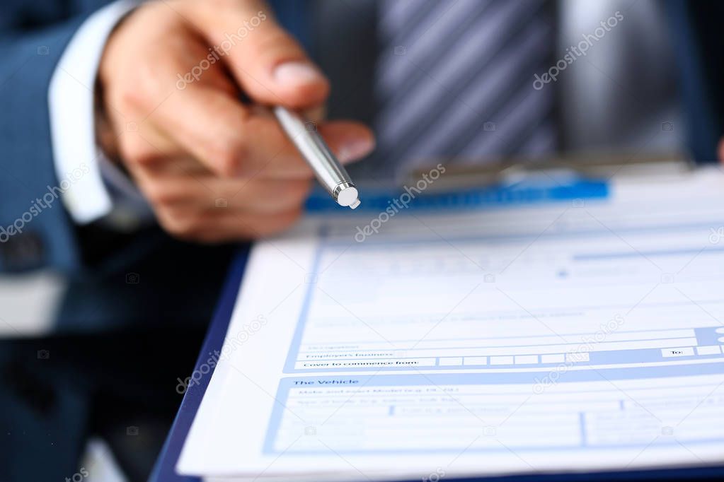 Male arm in suit offer contract form on clipboard pad