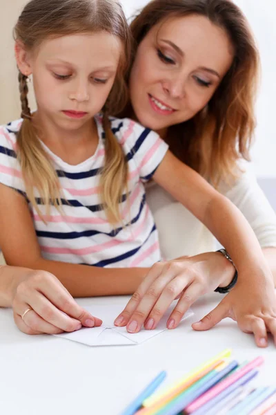 Blond smiling little girl make paper plane Royalty Free Stock Images