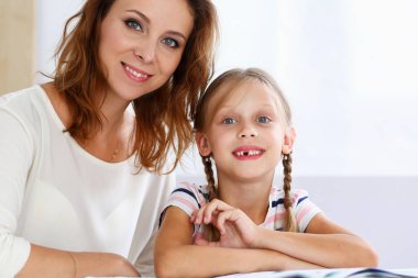 Sarışın anne ile birlikte küçük okuma gülümseyerek