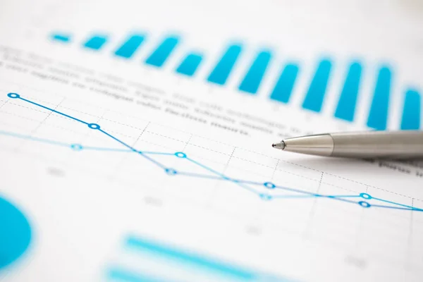 Financial statistics documents ball pen infographics at office table — Stock Photo, Image
