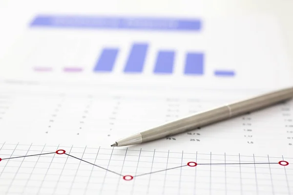 Financial statistics documents on clipboard pad at office table closeup — Stock Photo, Image