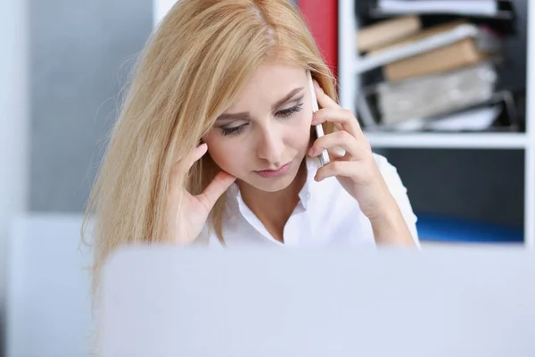 Beautiful blonde thoughtful businesswoman talk cellphone Royalty Free Stock Images