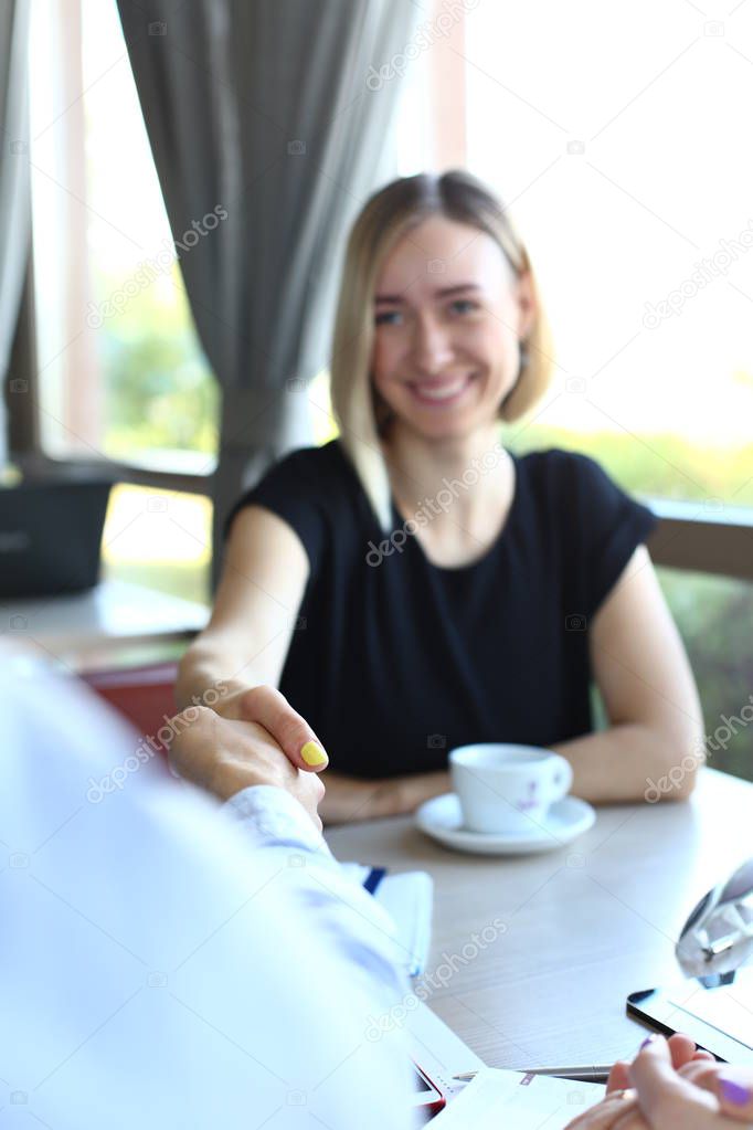 Smiling man and woman shake hands