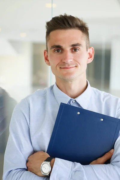 Handsome man in shirt and folder stand