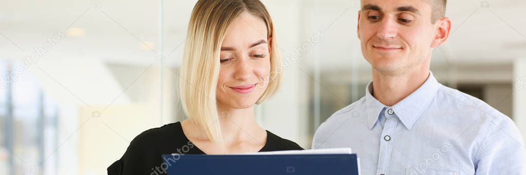 Beautiful woman portrait at workplace examining