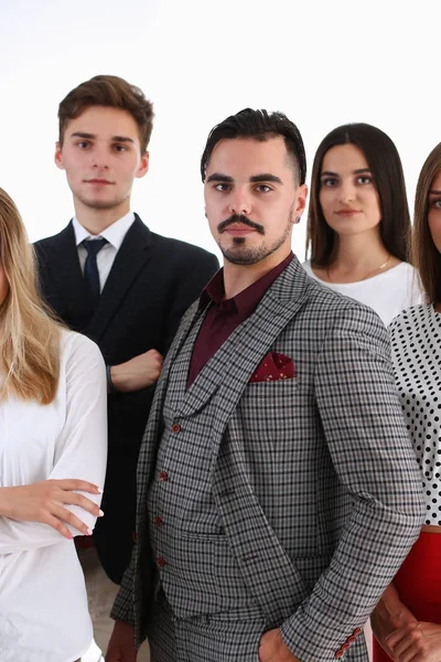 Group of smiling people stand in office