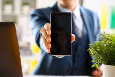Takım elbiseli erkek kolunu göster kamera telefon ekranını