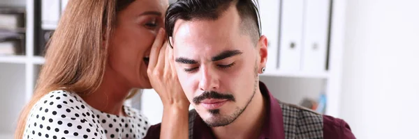 Woman gossip whispers in the ear of news to a man — Stock Photo, Image