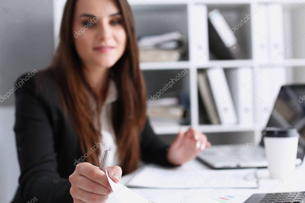 Female hand holding silver pen ready to make