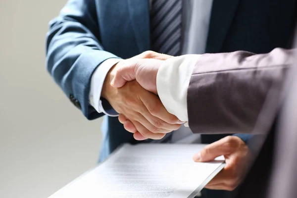 Man in suit shake hand as hello in office