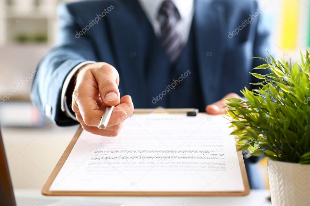 Male arm in suit offer contract form on clipboard