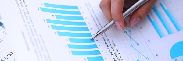 Businesswoman holding silver pen in hand