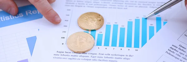 Oro btc signo de moneda acostado en las estadísticas gráfico de primer plano —  Fotos de Stock