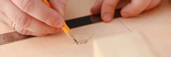 Arms of worker measuring wooden bar — Stock Photo, Image